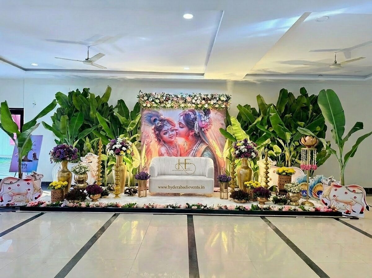 Krishna theme naming ceremony decoration with banana leaves, floral arrangements and traditional backdrop.