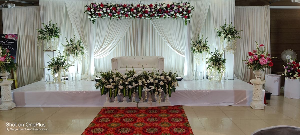 Peach floral ring wedding reception stage decoration with designer carved sofa and soft fairy lighting