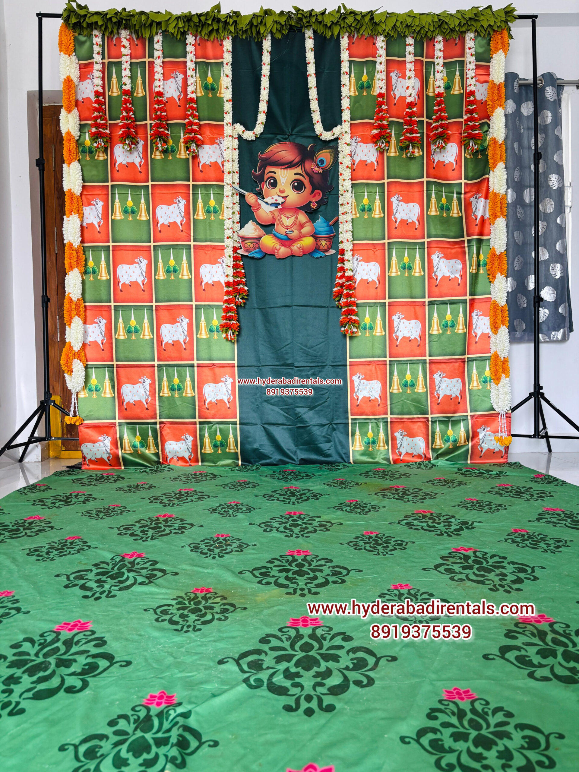 Baby Krishna themed traditional backdrop rental with floral garlands and festive South Indian decor for cradle ceremony and naming function in Hyderabad.