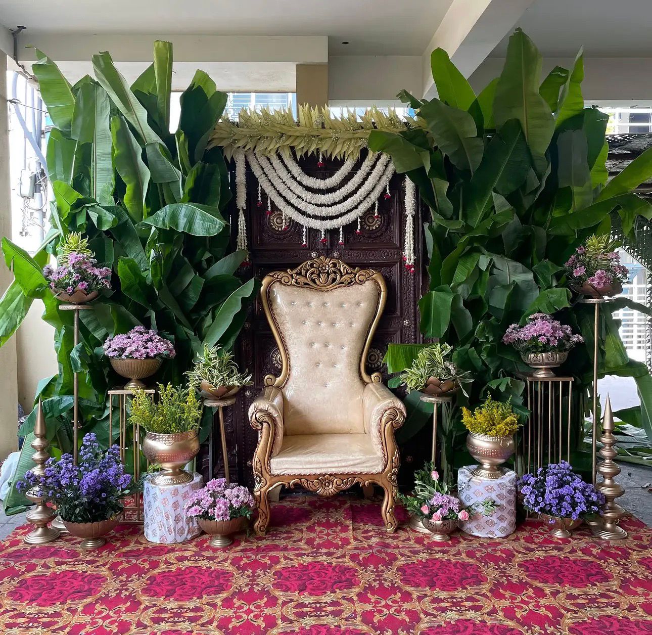 Traditional banana leaf Seemantham decoration with jasmine garlands and floral backdrop