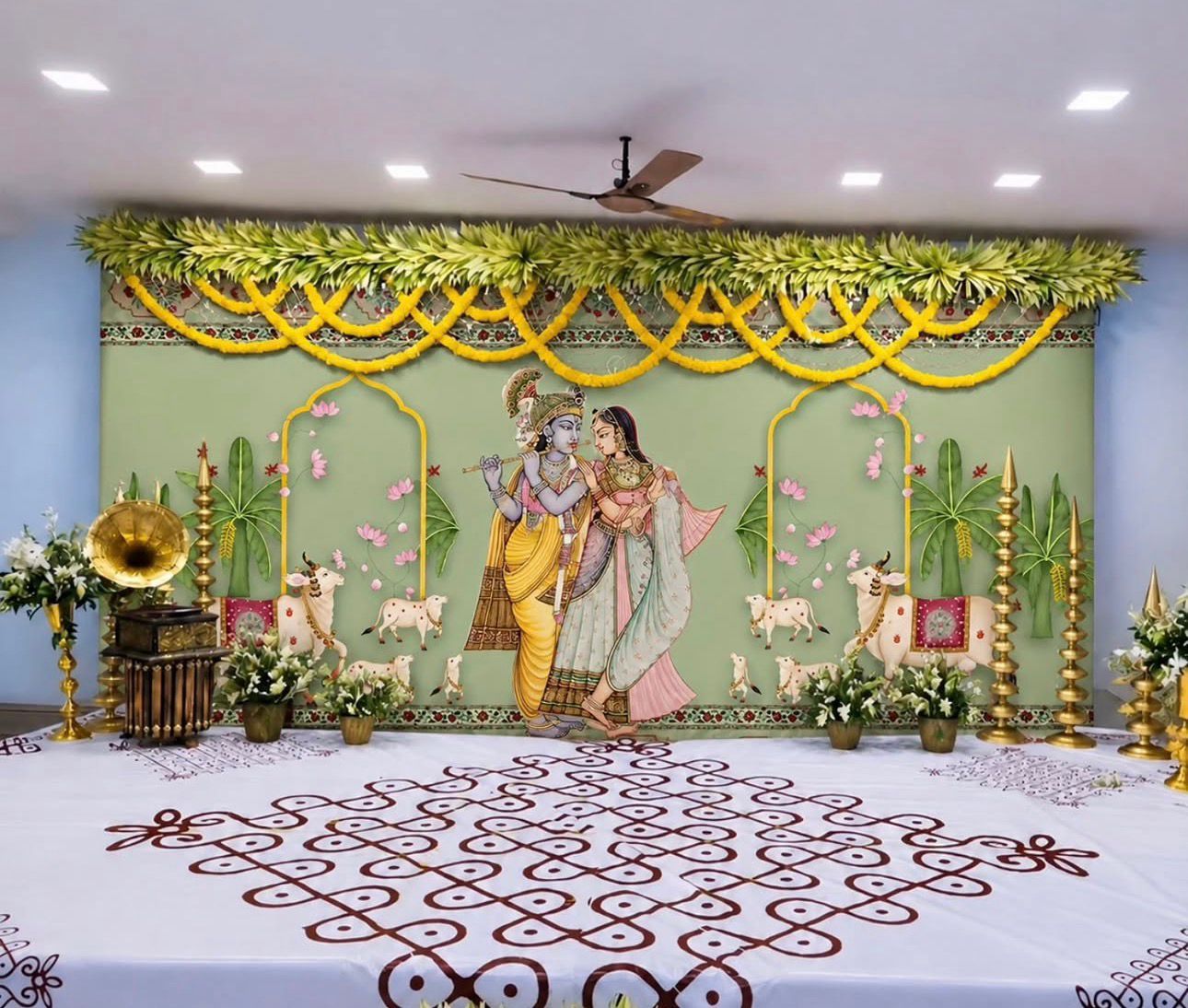 Radha Krishna traditional backdrop decoration with brass lamps and floral styling