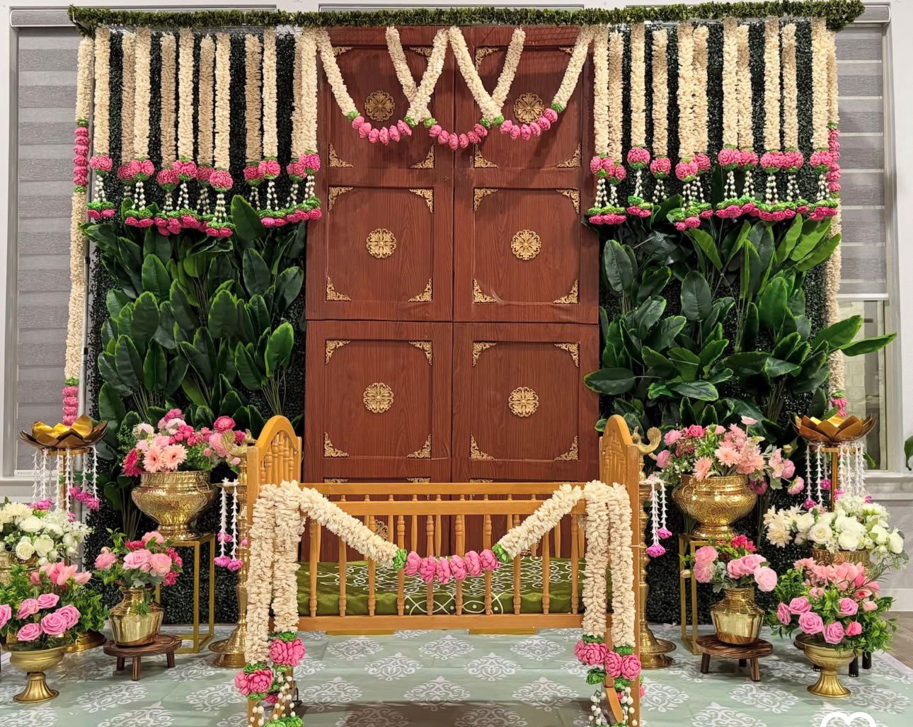 Luxury cradle ceremony decoration with floral backdrop and wooden cradle setup