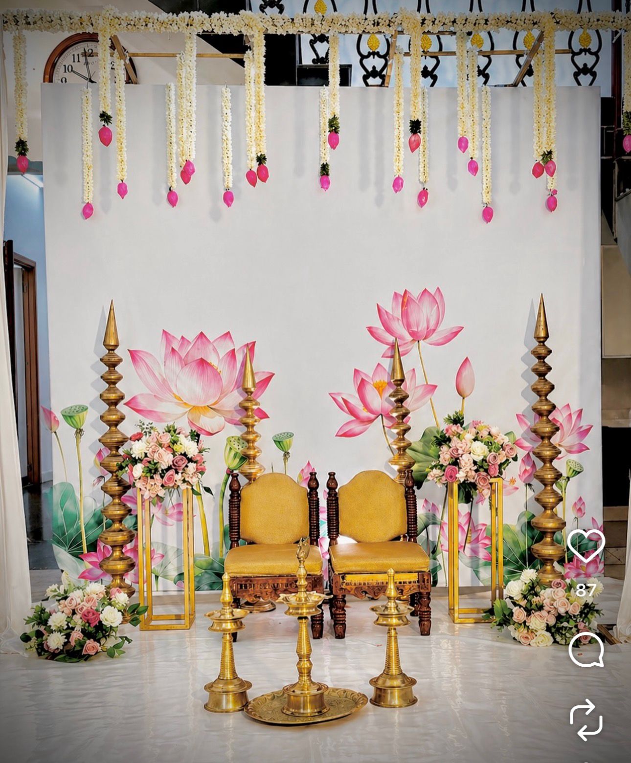 Lotus themed Seemantham decoration with floral backdrop and brass lamp arrangements