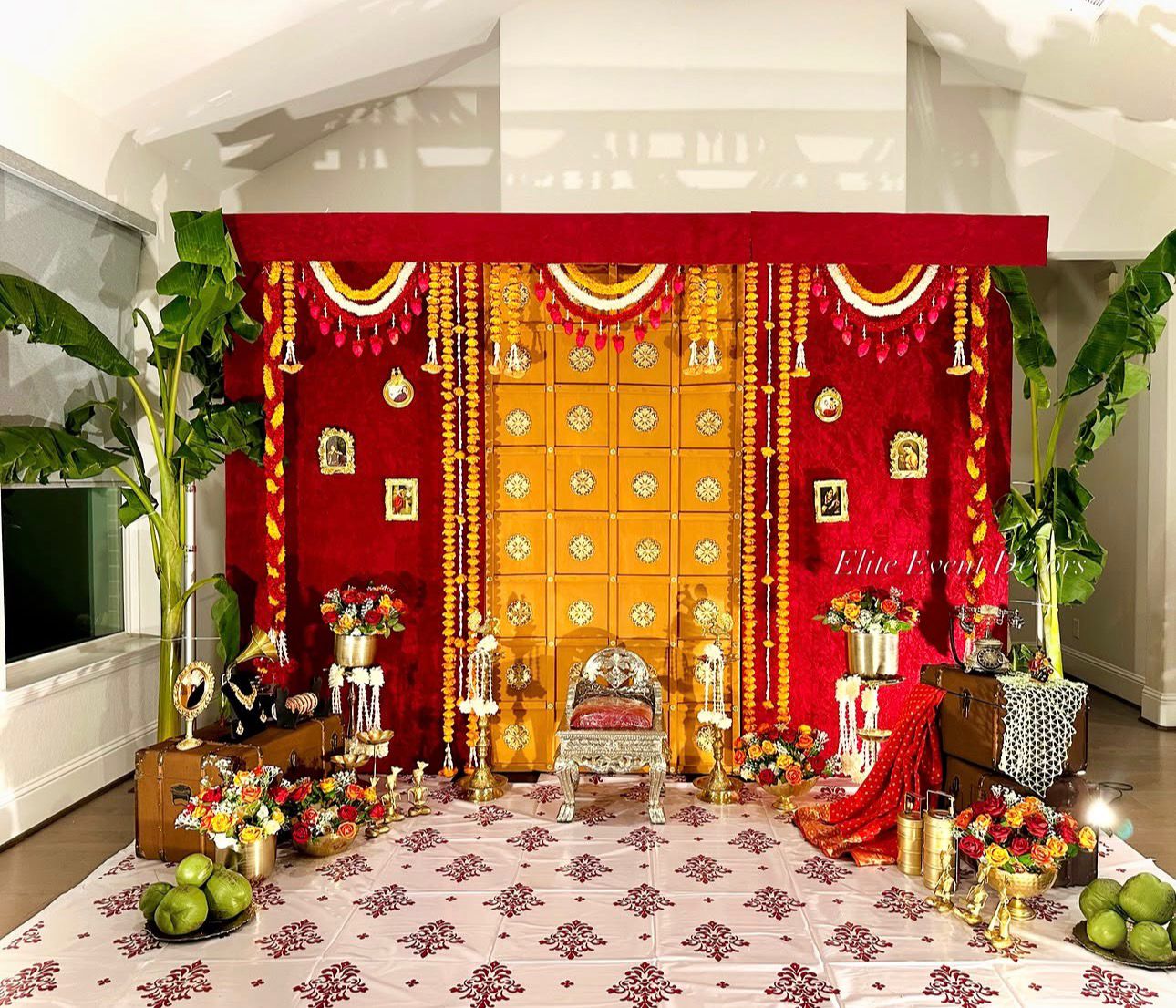 Royal heritage themed Seemantham decoration with traditional wooden backdrop, floral garlands and antique props
