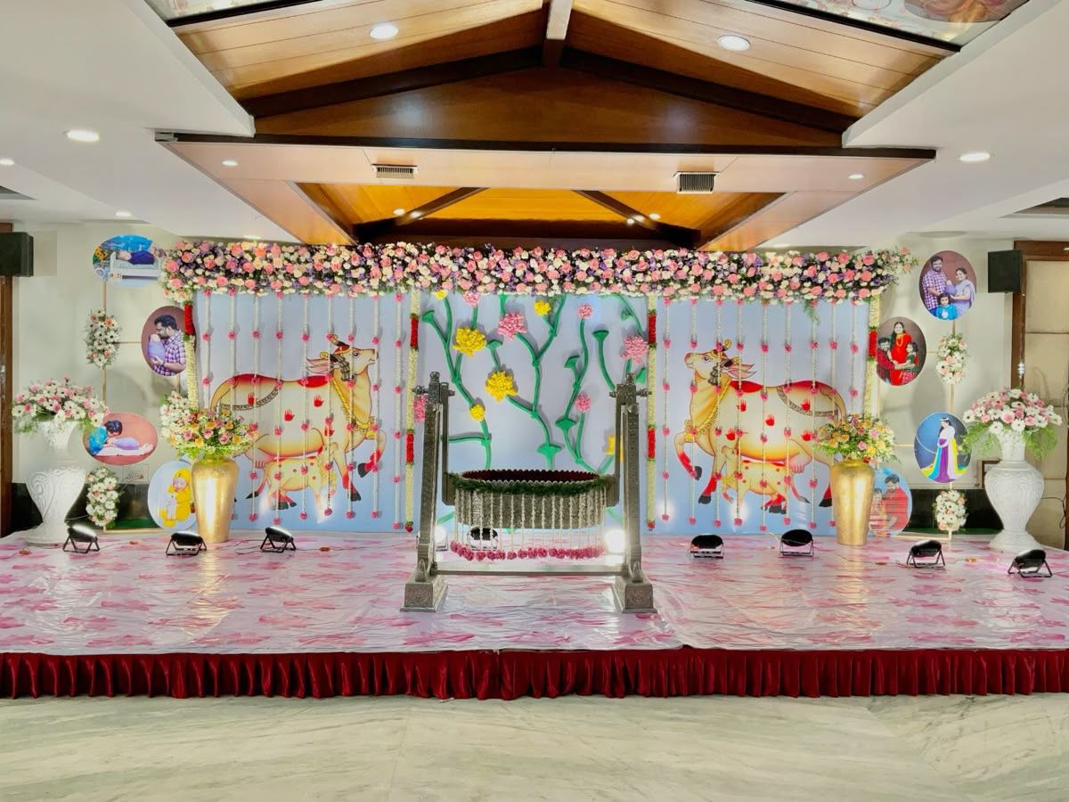 Traditional Krishna theme Annaprasana cradle decoration with floral backdrop and custom baby ceremony setup in Hyderabad