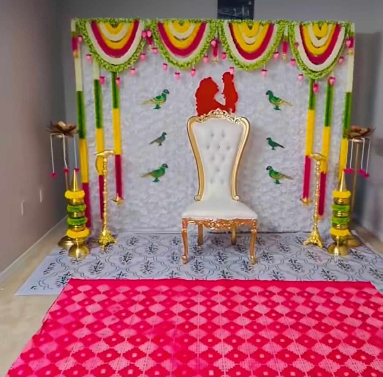 Traditional floral baby shower backdrop decoration with colorful garlands, floral backdrop, royal chair and South Indian event styling in Hyderabad.