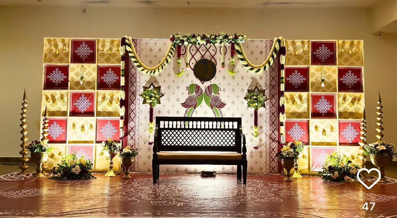Designer traditional Seemantham decoration with illuminated box panels, floral garlands, wooden bench, brass lamps and premium South Indian baby shower stage.