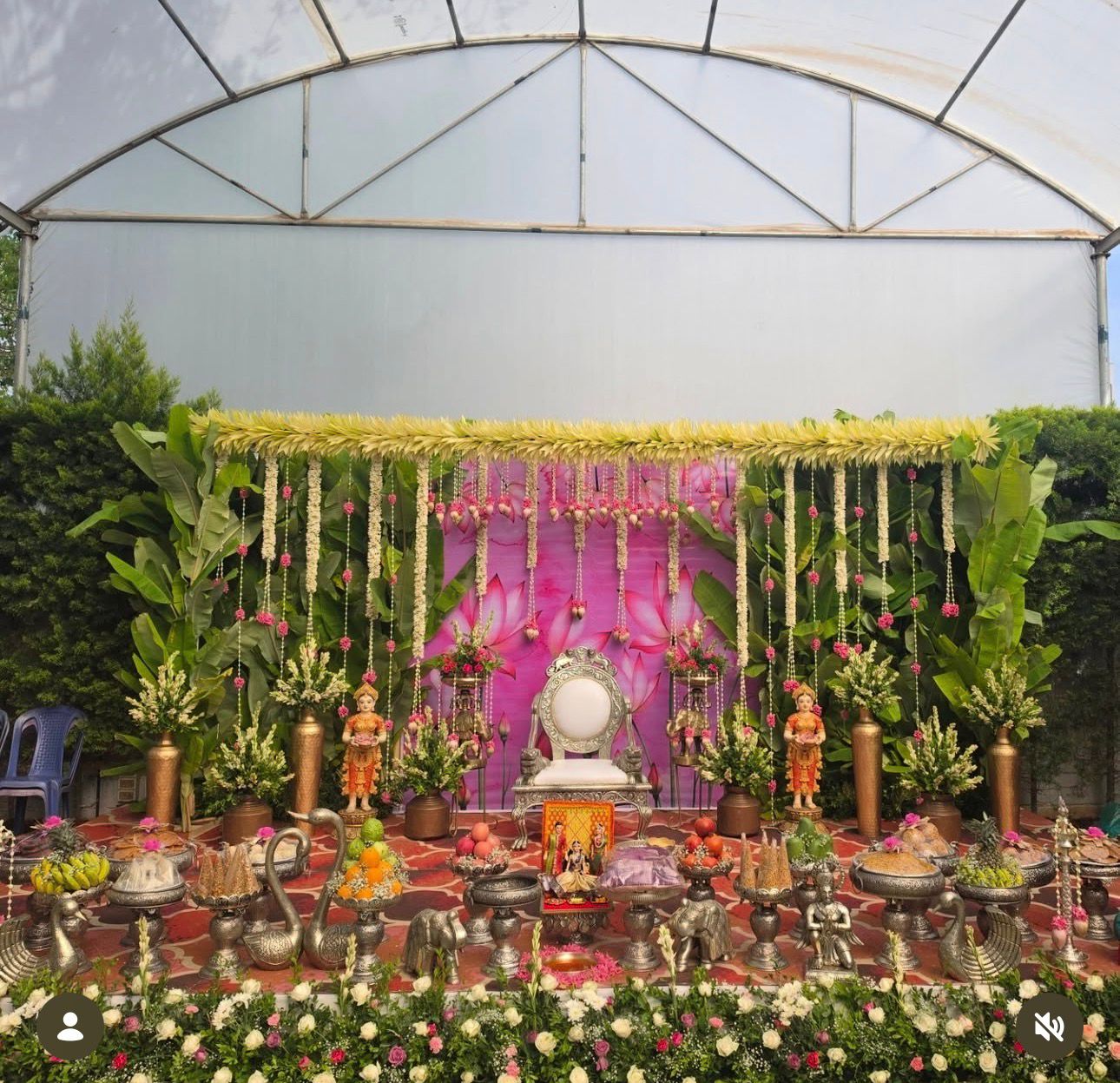 Grand outdoor Seemantham decoration with banana leaves, jasmine garlands, silver pooja setup, floral backdrop and traditional baby shower stage.